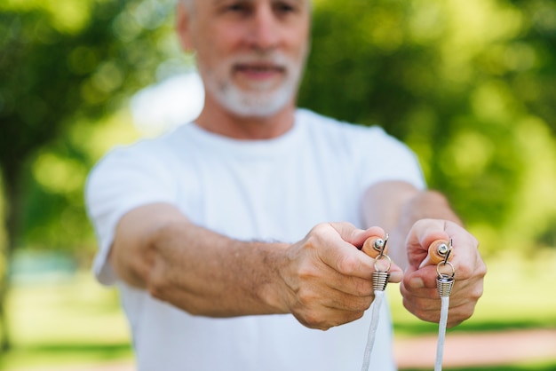 Close-up man holding jumping rope