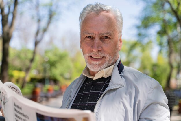 Close up man holding newspaper