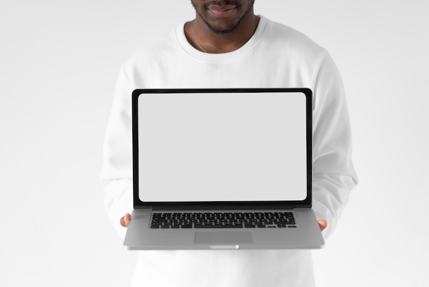 Free photo close up man holding open laptop