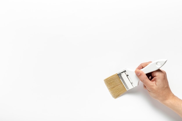 Close-up man holding a painting brush