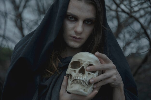 Close-up man holding a realistic cement skull