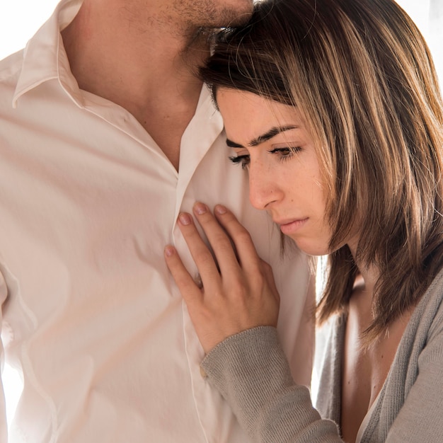 Close-up man holding sad woman