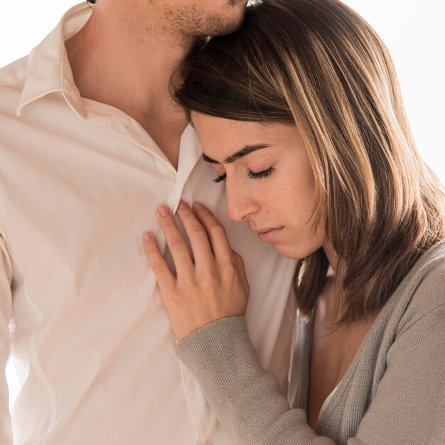 Close-up man holding upset woman