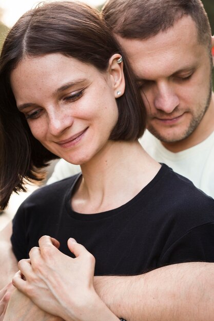 Close-up man holding woman