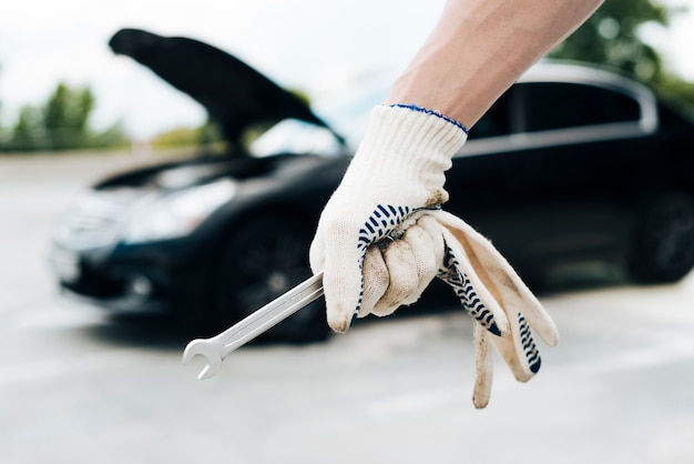 Close up of man holding wrench