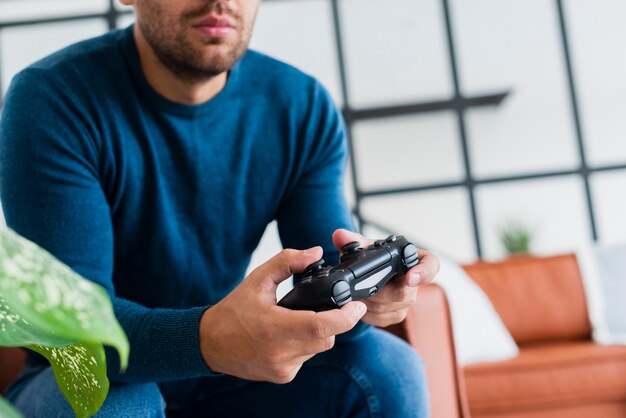 Close-up man at home playing games