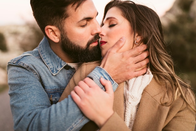 Close-up man kissing beautiful woman