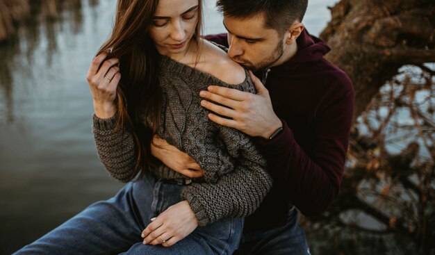 Close-up man kissing woman's shoulder