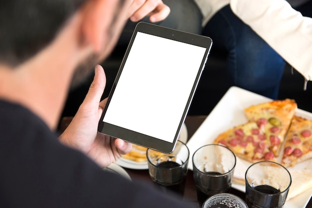 Close-up of man looking at blank digital tablet