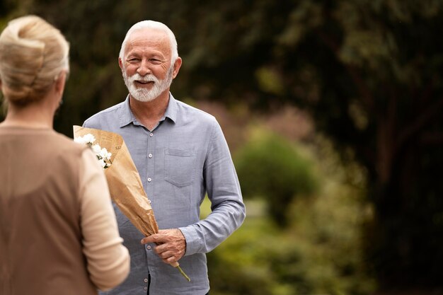 Close up man offering flowers