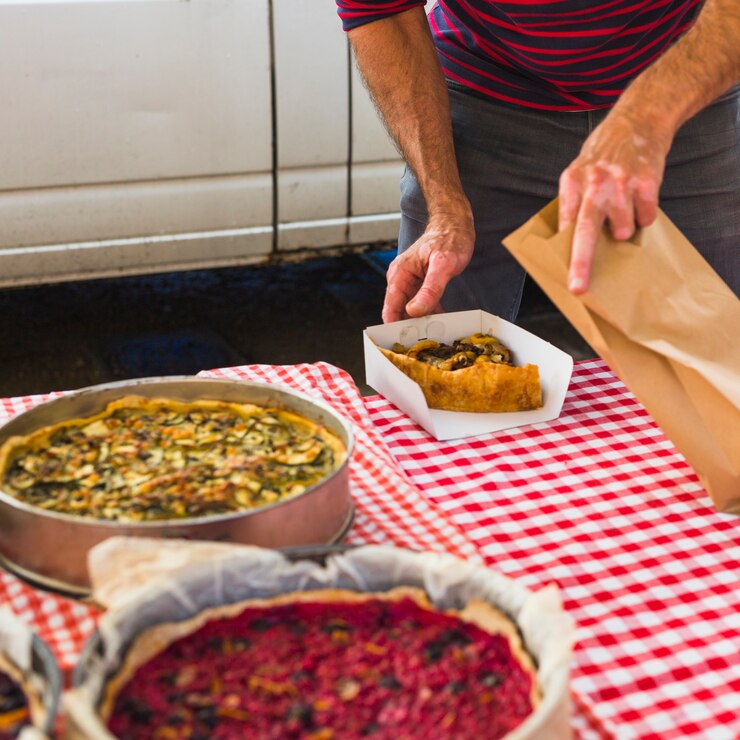 Close-up of a man packing a slice of fruit tart in the paper bag
Hobo Pie Maker