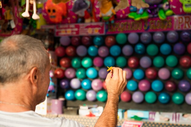 Close-up man playing darts