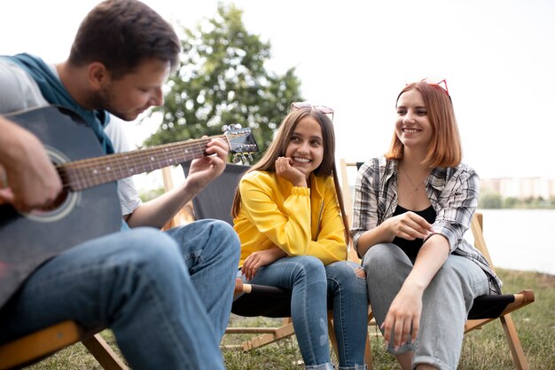 Close up man playing the guitar outdoors