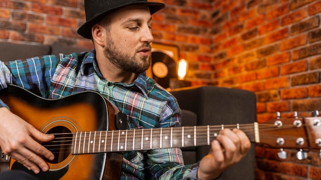 Close-up man playing the guitar