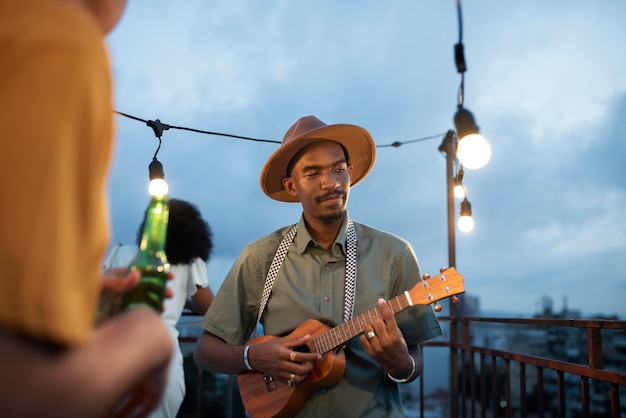 Close up man playing the ukulele