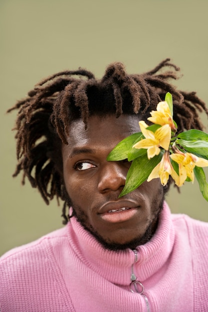 Close up man posing with flowers