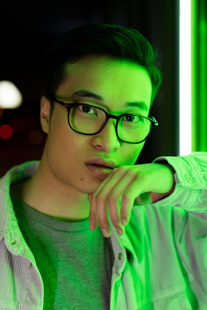 Close up man posing with neon light