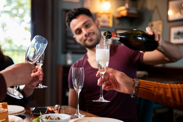 Free photo close up man pouring champagne