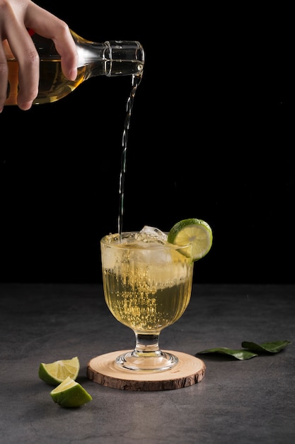 Free photo close-up man pouring drink in a glass