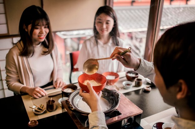 Close up man pouring food in bowl