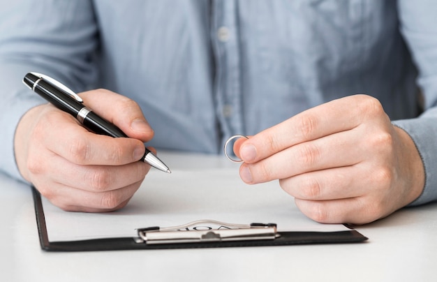 Close-up man prepared to sign divorce contract
