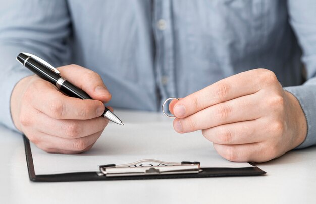 Close-up man prepared to sign divorce contract