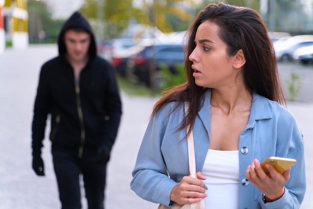 Close up on man preparing to steal from young woman