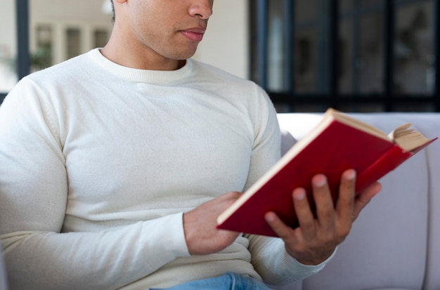 Close-up of man reading a book