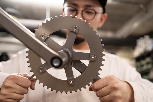 Free photo close up man repairing bike