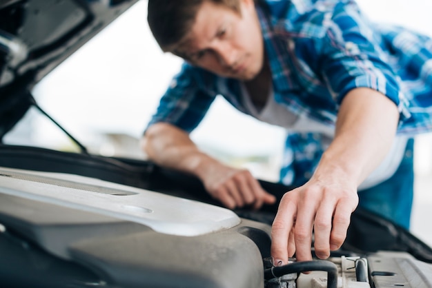 Close-up of man repairing engine