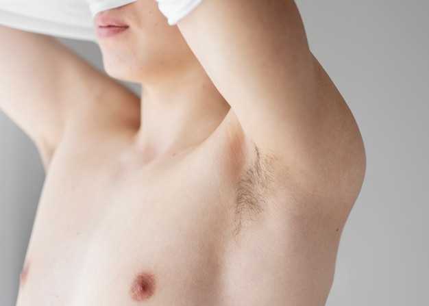 Close up on man revealing her armpit
