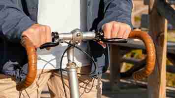 Foto gratuita chiuda sulla bicicletta di guida dell'uomo