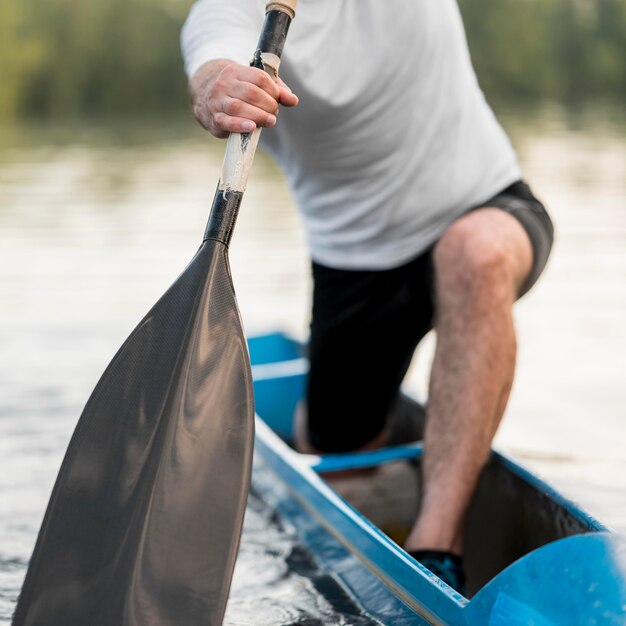 Close-up man rowing with oar