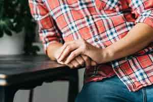 Free photo close-up of man's clasped hand on wooden table