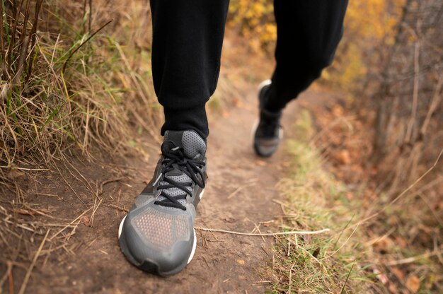 Close-up man's feet in forest