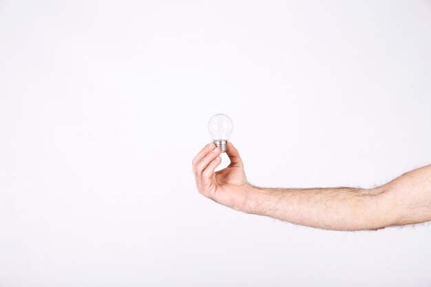 Close-up of a man's hand holding light bulb