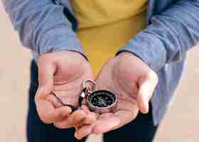 Free photo close-up of man's hand holding navigational compass