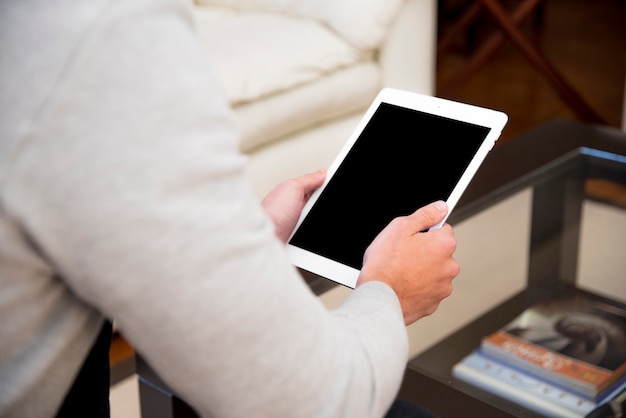 Close-up of a man's hand using digital tablet