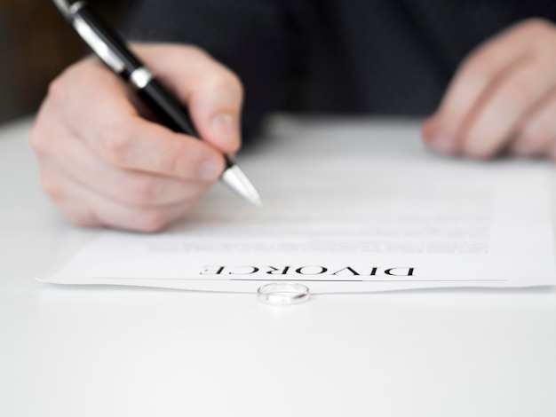 Free photo close-up man signing divorce contract