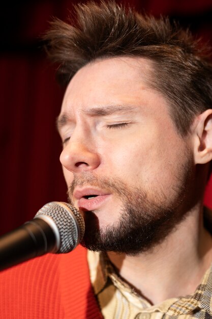 Close up man singing with microphone