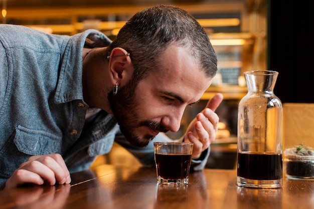 一杯のコーヒーの臭いがする男のクローズアップ