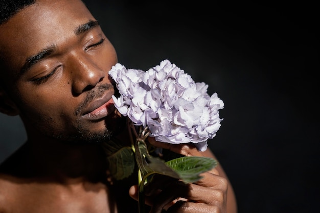 Close-up Man Smelling Flowers