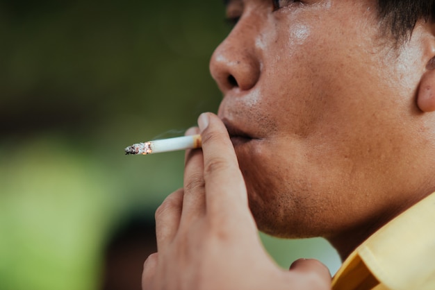 Close up man smoking a cigarette