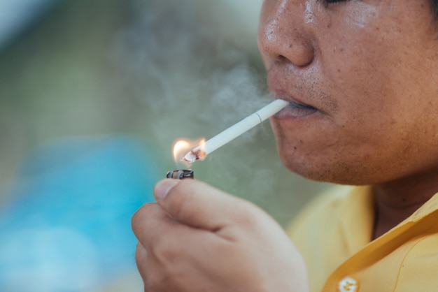 Close up man smoking a cigarette