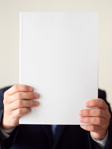 Close-up man in suit with notebook