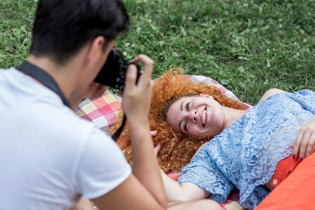 Close up man taking a photo of a woman