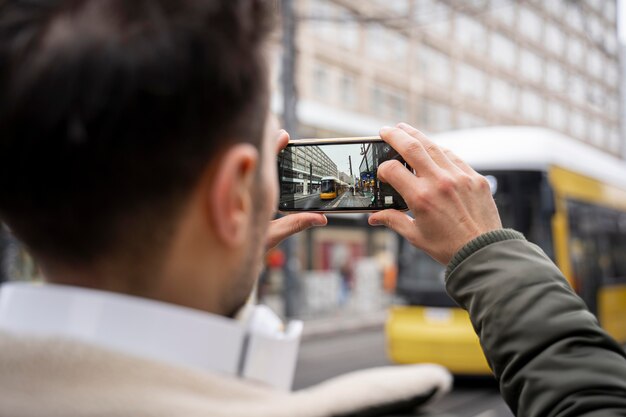 Close up man taking photos in city