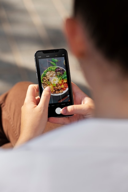 Close up man taking photos with device