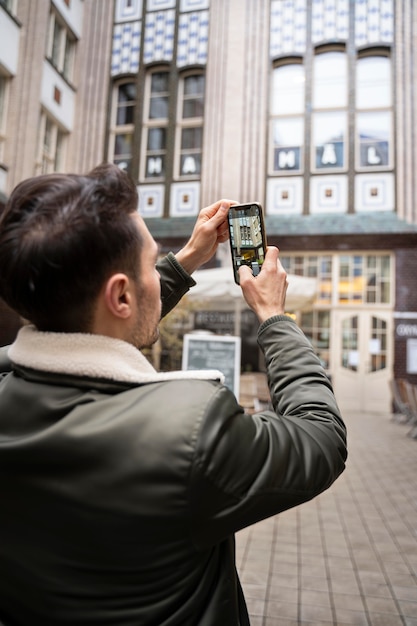 Close up man taking photos with phone