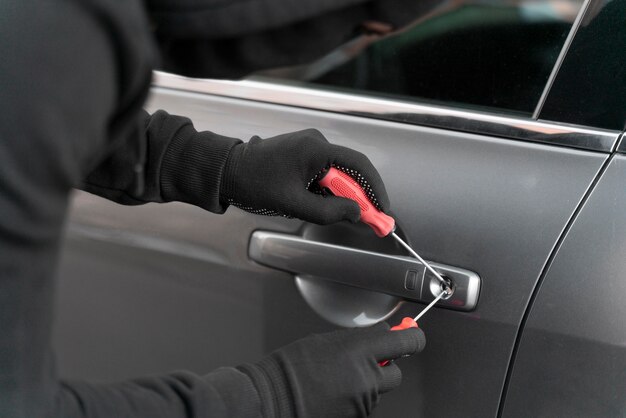 Close up on man trying to break into a car